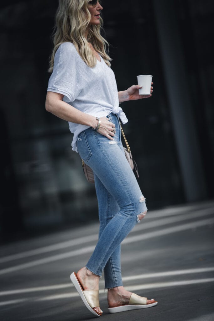 So Heather wearing gold slides and white tee