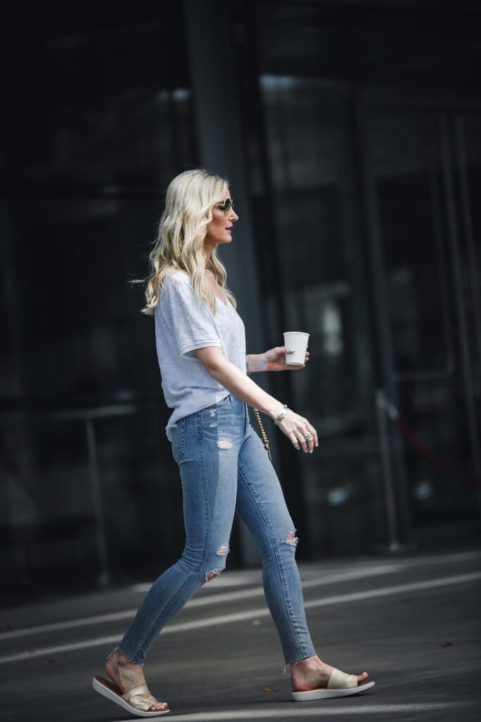 So Heather wearing ripped jeans, white tee, and gold slides