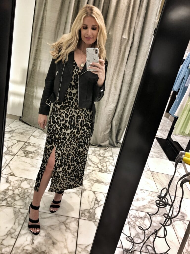 Dallas fashion blogger wearing a leopard midi dress and moto jacket