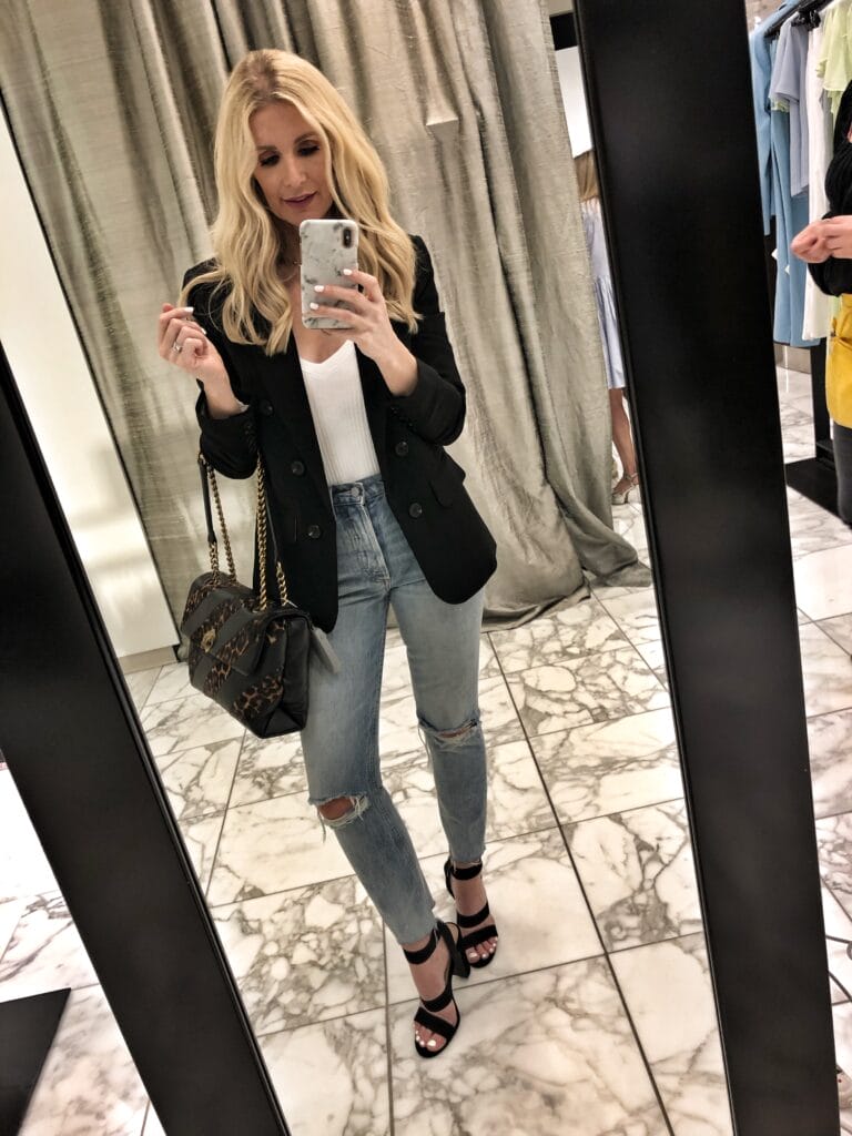 Dallas influencer wearing a black blazer and ripped jeans