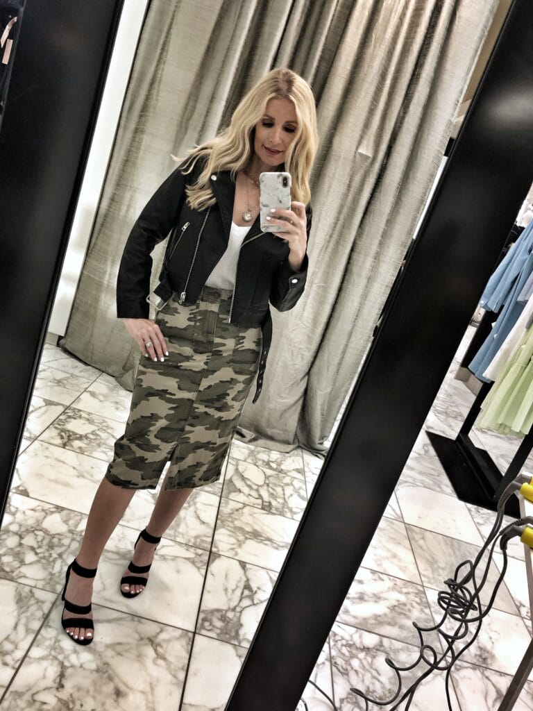 Dallas influencer wearing a camo midi skirt and a leather jacket