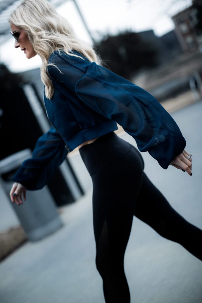 Dallas fitness blogger wearing Alo yoga cropped bomber jacket