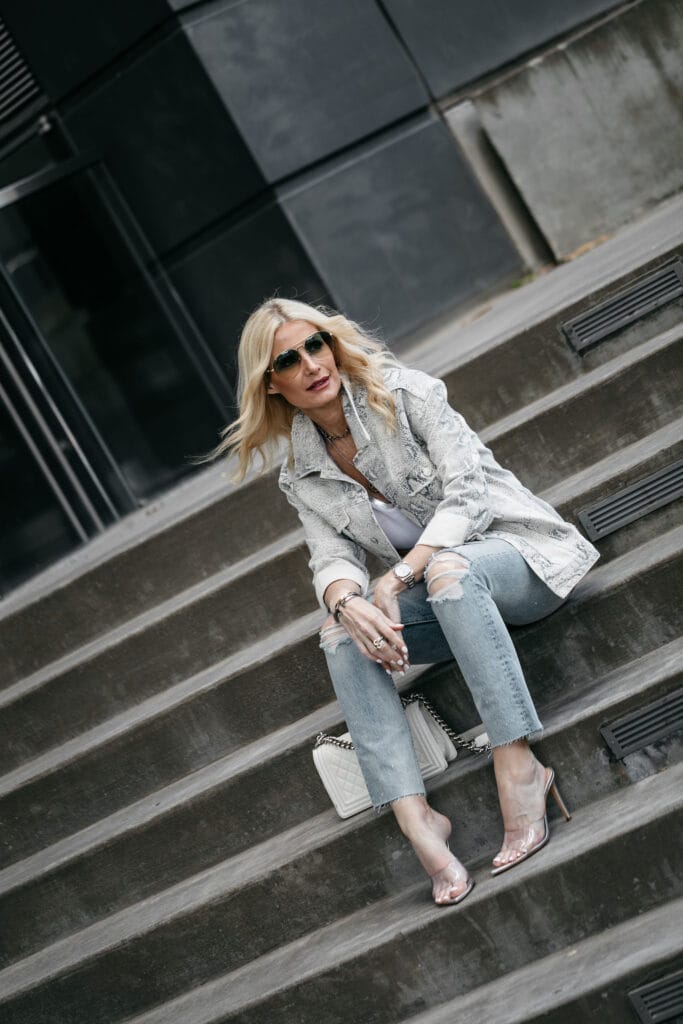 Dallas fashion influencer wearing snake print jacket and ripped jeans