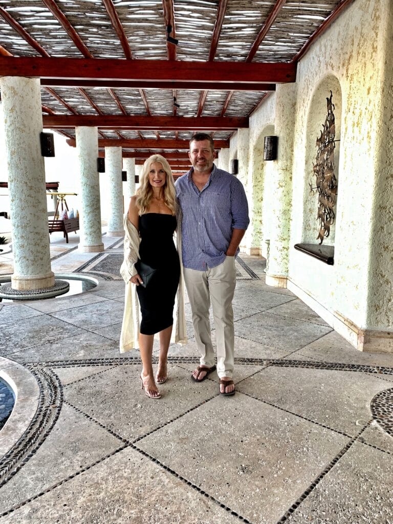 Dallas blonde woman wearing a black midi dress