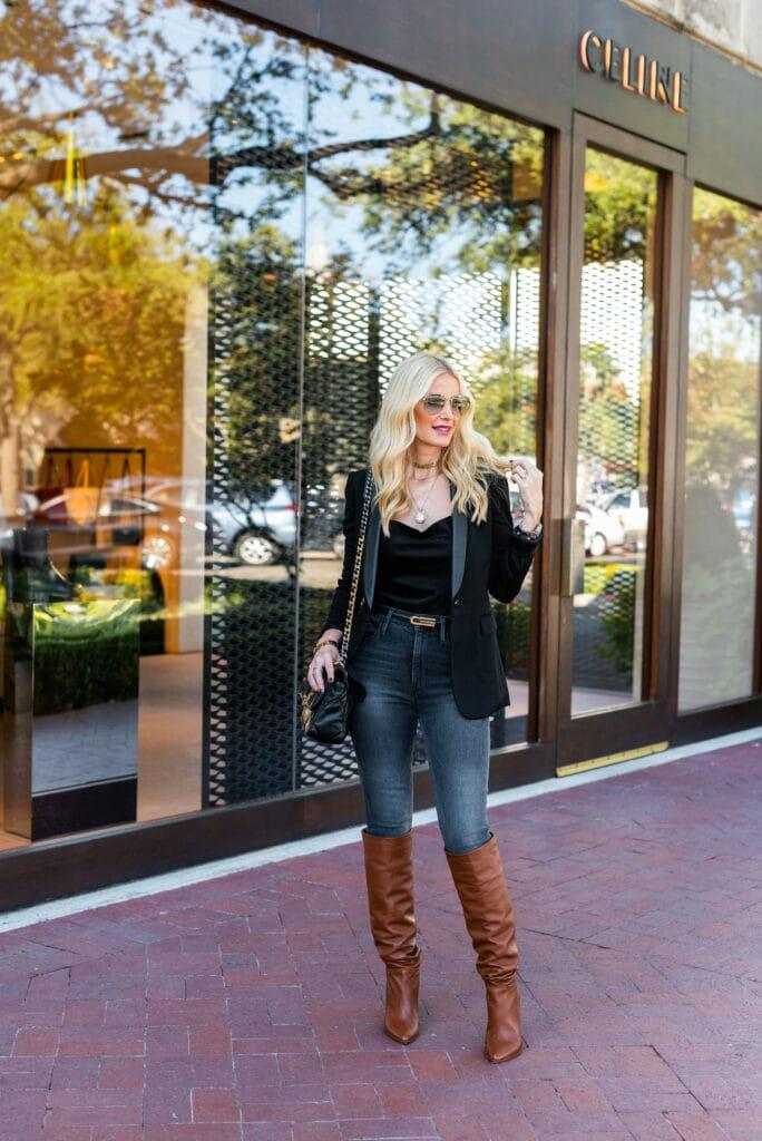 Style blogger wearing a black blazer and denim