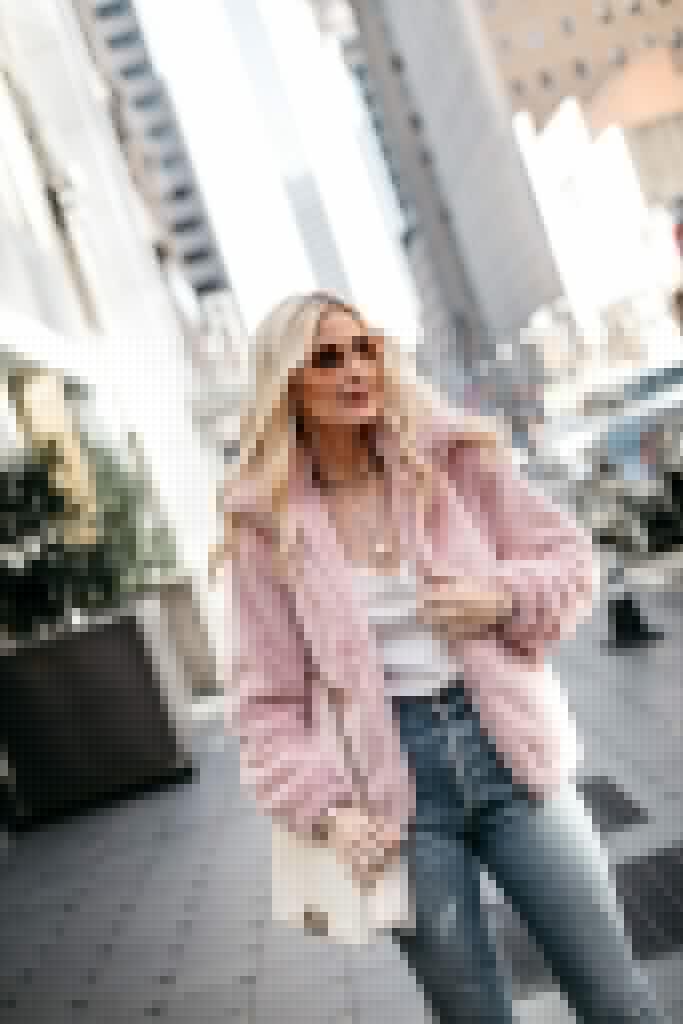 Fashion blogger wearing a pastel colored jacket in winter