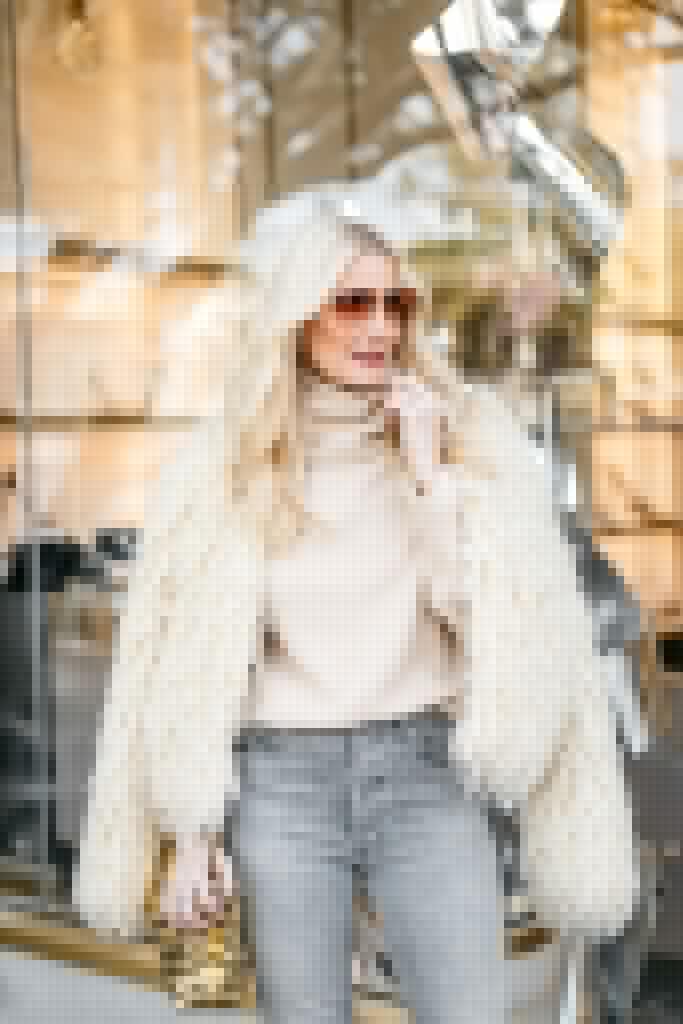 Dallas blogger wearing a faux fur jacket and a sweater