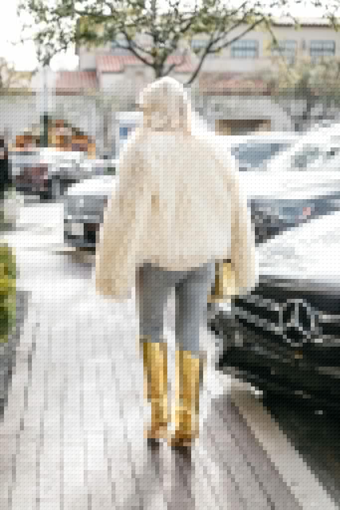 Dallas influencer wearing a faux fur jacket and gold boots