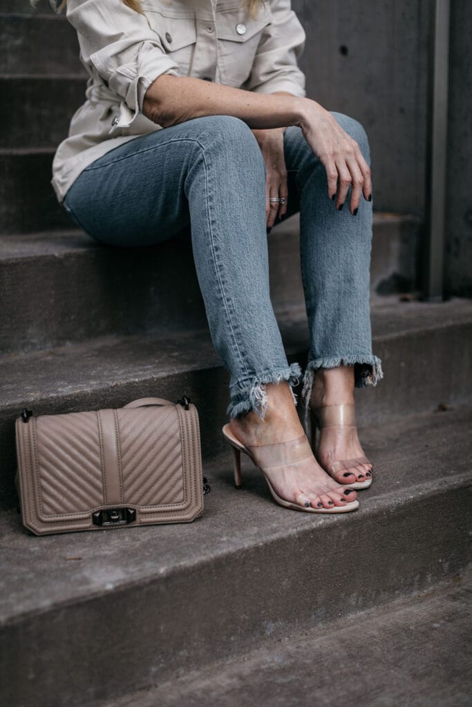 Dallas influencer wearing ripped jeans and nude heels by Schutz