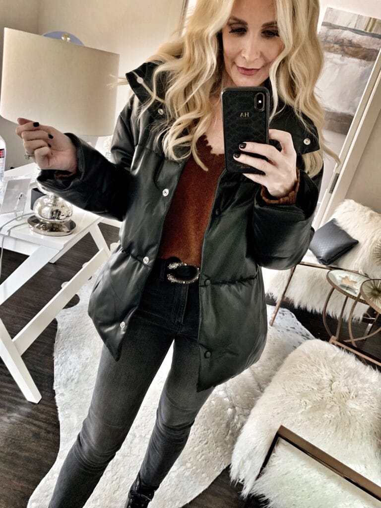 Style blogger wearing a black jacket with black denim