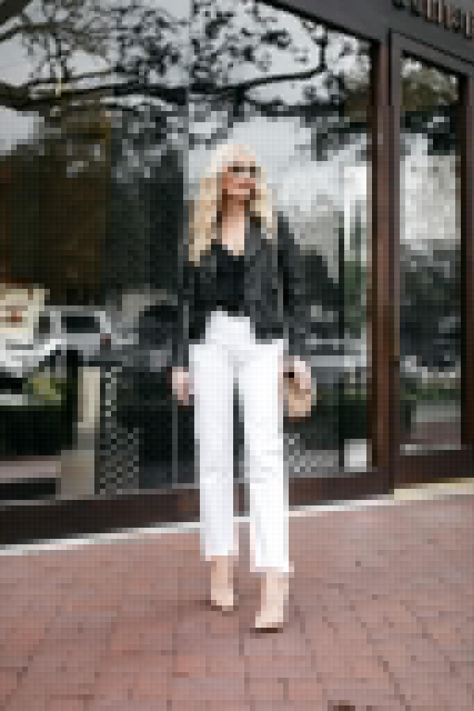 Dallas blogger wearing a black leather jacket and white jeans