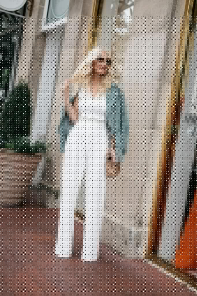 Dallas influencer wearing a moto jacket and a white jumpsuit