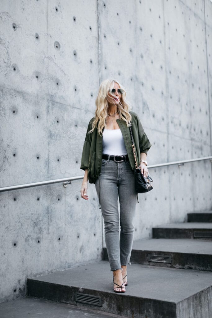 Dallas fashion blogger wearing grey jeans and a jacket