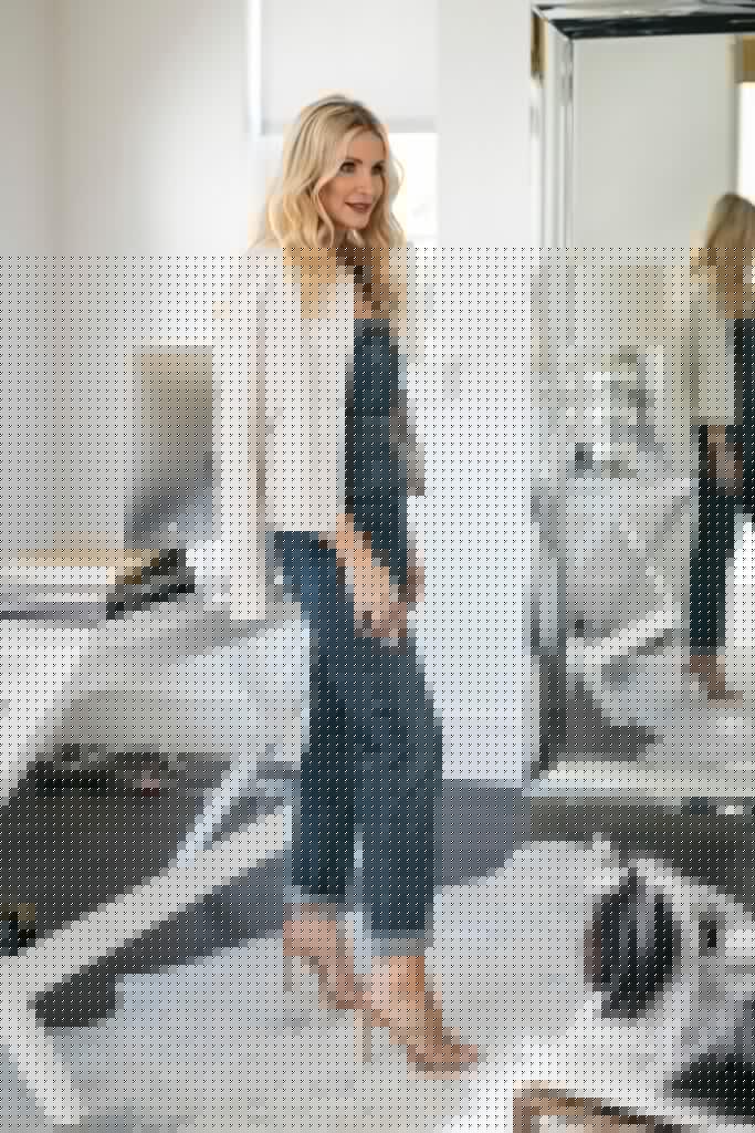 Dallas blogger wearing a denim jumpsuit and a white jacket