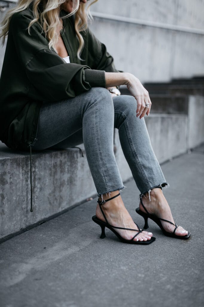 Dallas fashion blogger wearing a dark green jacket with light wash denim
