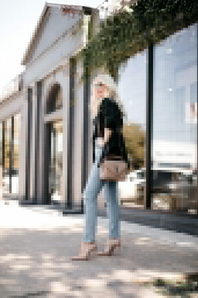 Influencer wearing a black blazer with denim and heels