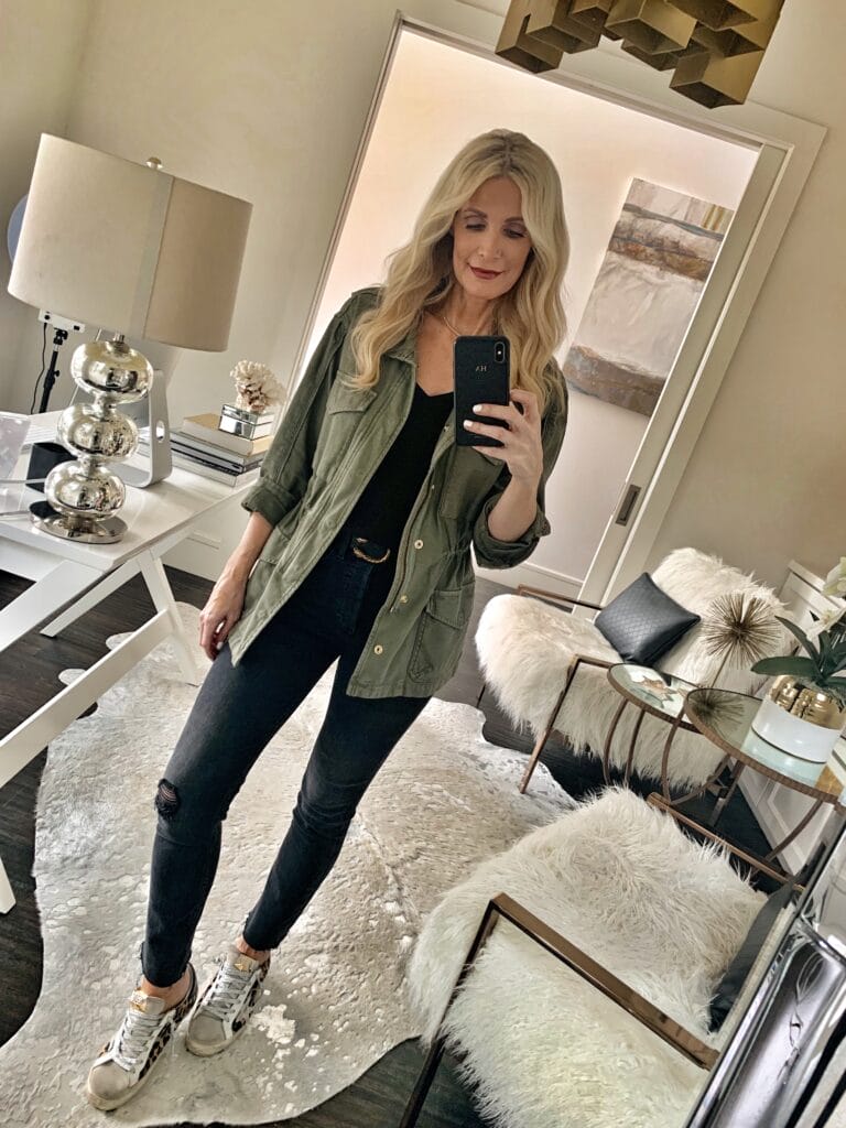 Style influencer wearing an army jacket and black denim
