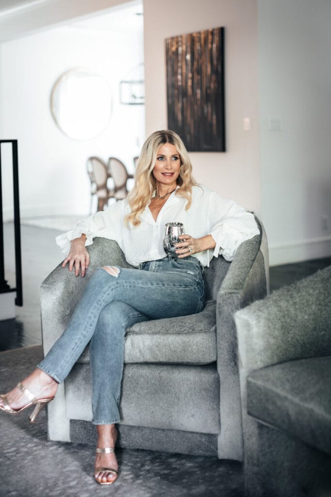 Fashion blogger wearing a white blouse and gold heels for summer