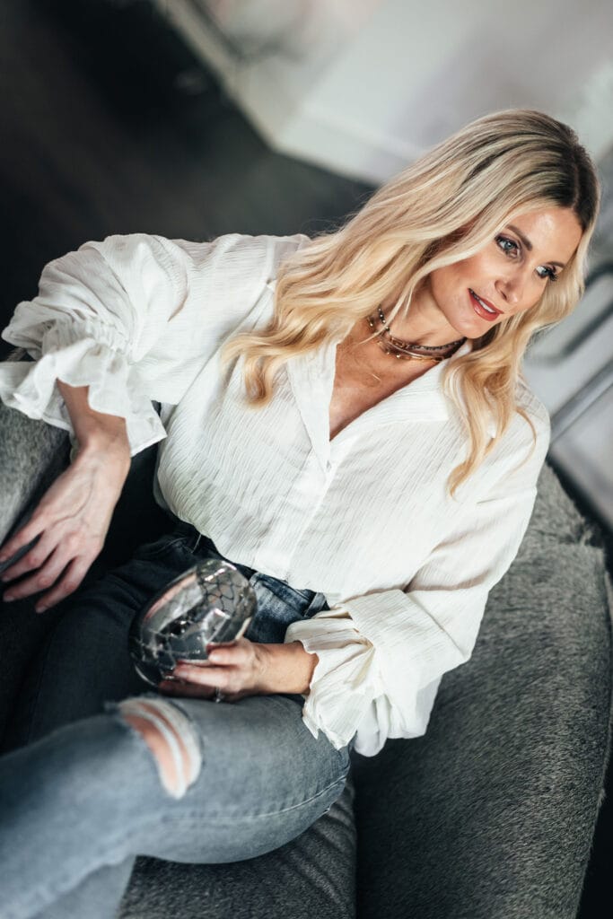 Dallas influencer wearing a white summer top with gold necklaces