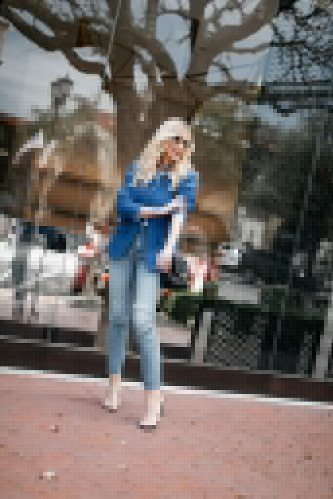 Fashion blogger wearing a blue blazer and light wash denim
