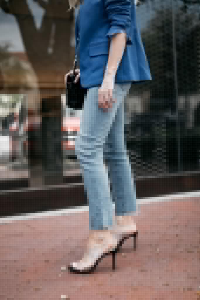 Dallas style blogger wearing light wash jeans and heels