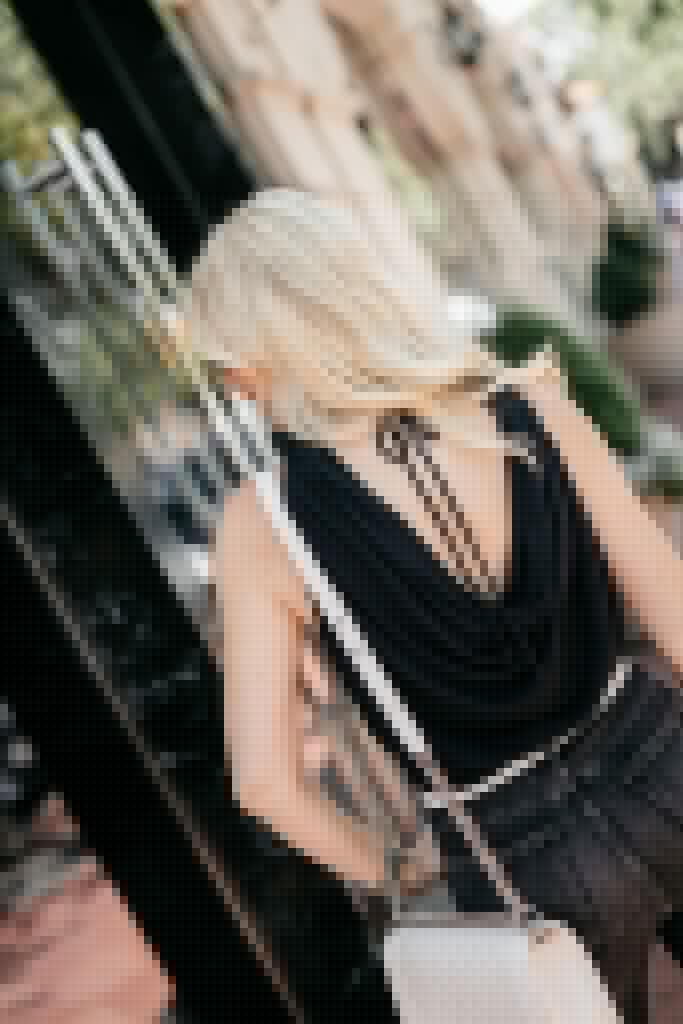 Dallas influencer wearing a black date night top with an open back