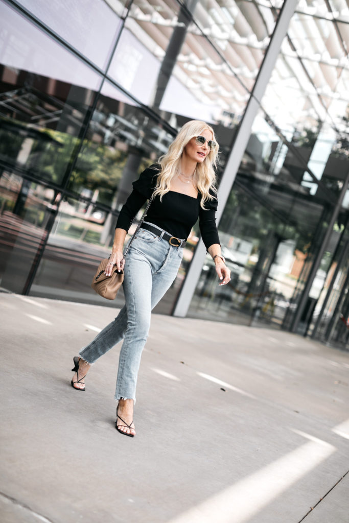 Dallas fashion blogger wearing a black top and light wash denim