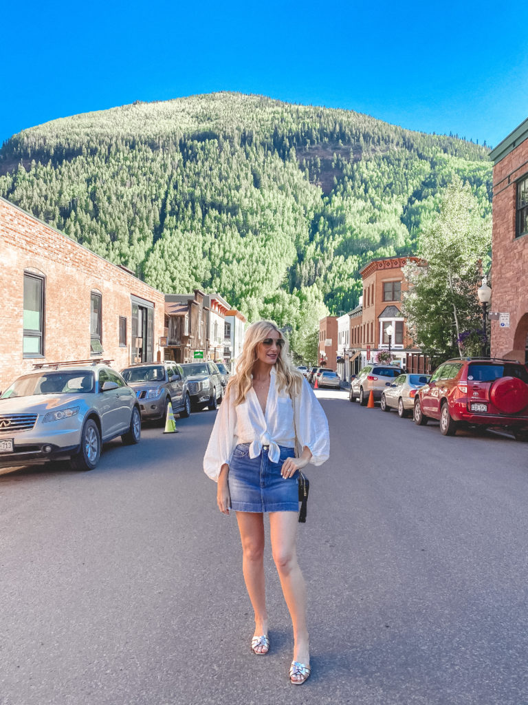 Dallas blogger wearing a denim skirt and white blouse for Fourth of July