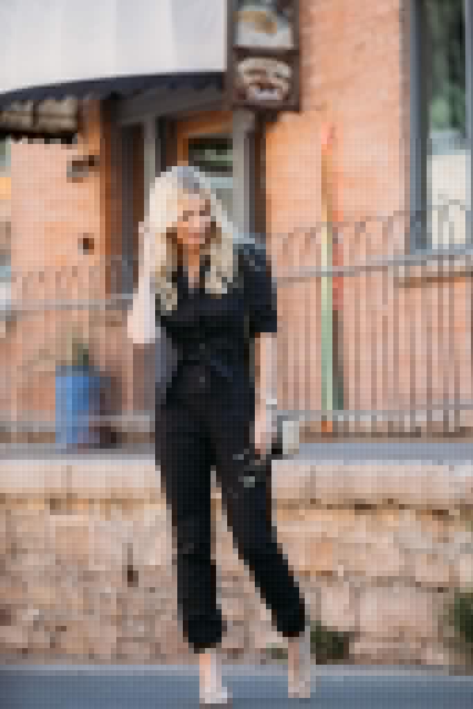 Dallas influencer wearing a black denim jumpsuit