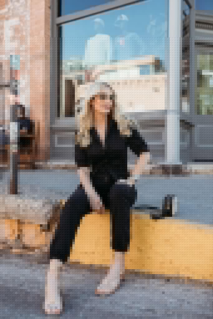 Dallas blogger wearing a black jumpsuit by Paige