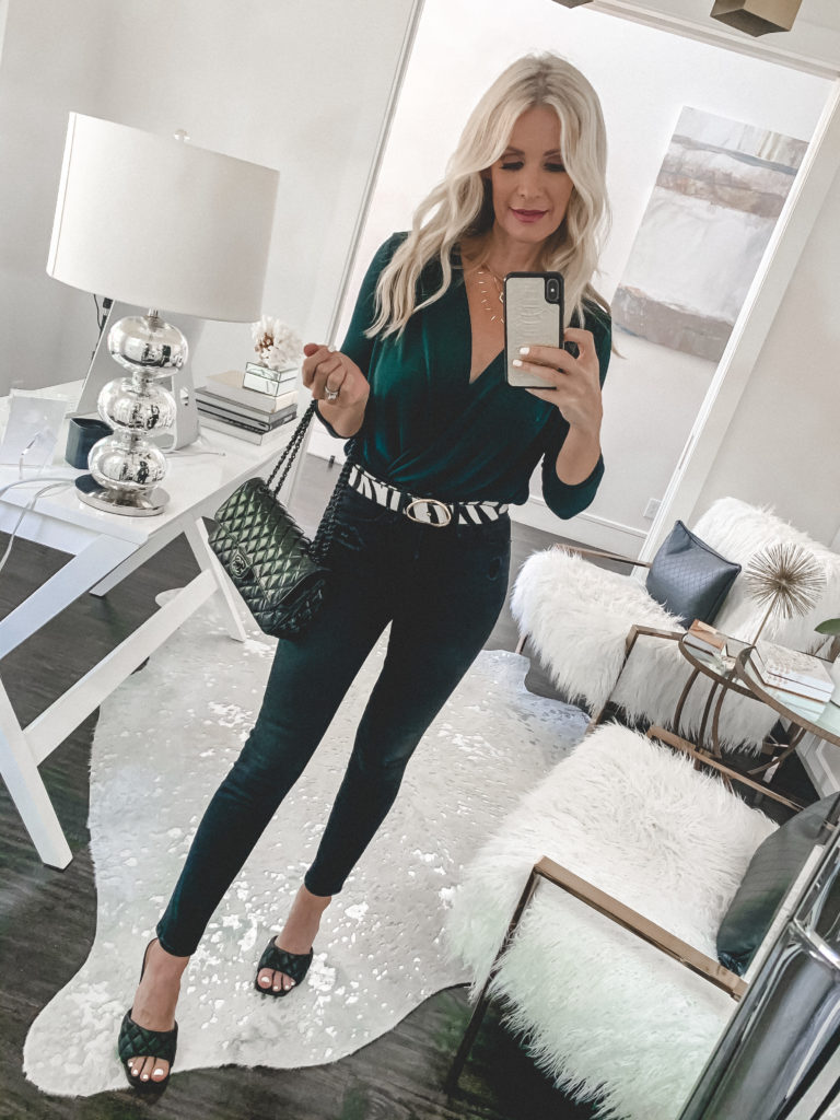 Dallas blogger wearing an emerald green bodysuit and black denim