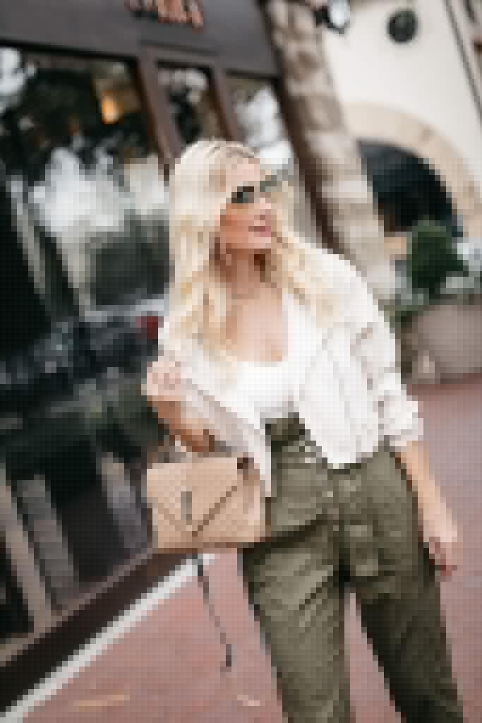 Fashion blogger wearing a neutral YSL bag and a faux leather white jacket