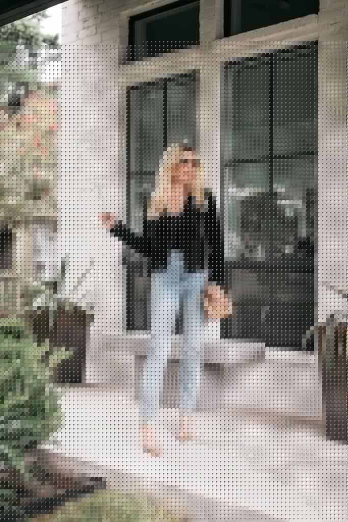 Dallas fashion blogger wearing a black fringe jacket and light wash denim for fall