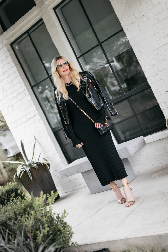 Style blogger wearing a black ribbed dress and a leather Moto jacket