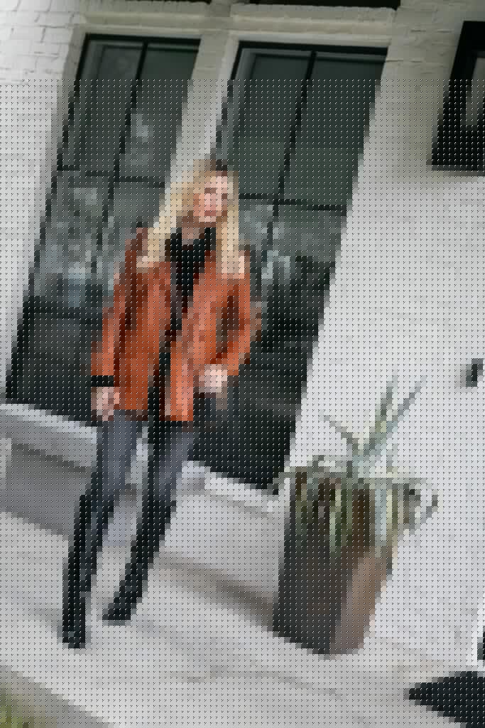 Dallas fashion blogger wearing a rust leather jacket and black boots for winter