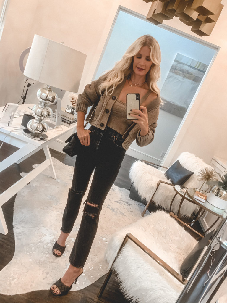 Dallas blogger wearing a cashmere sweater and crop top set and black denim