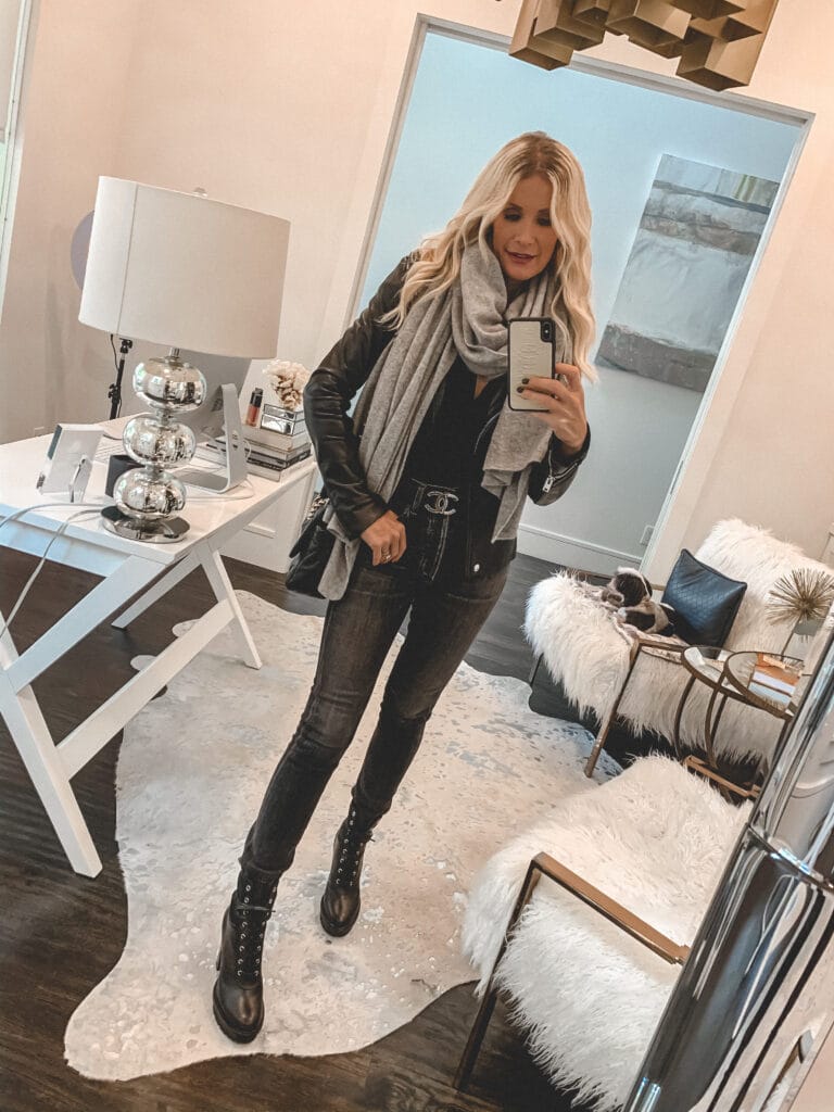 Style blogger wearing a cozy cashmere scarf and a leather jacket with combat boots