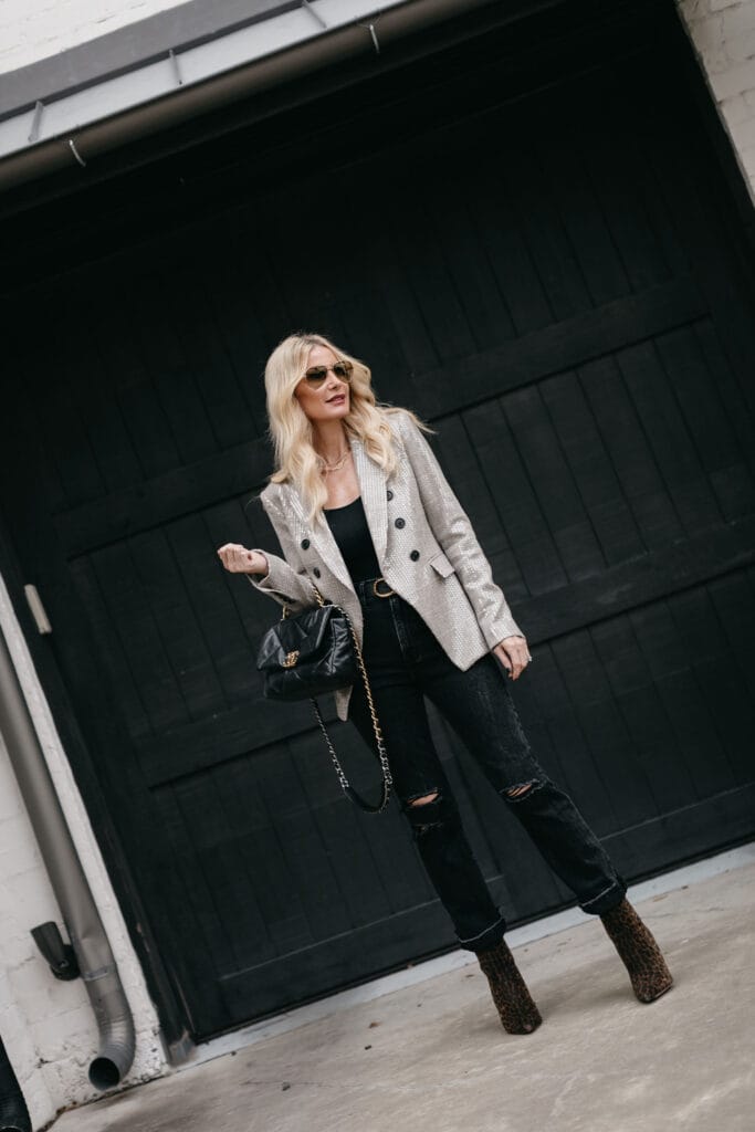 Dallas blogger wearing a blazer and faded black denim with a Chanel handbag
