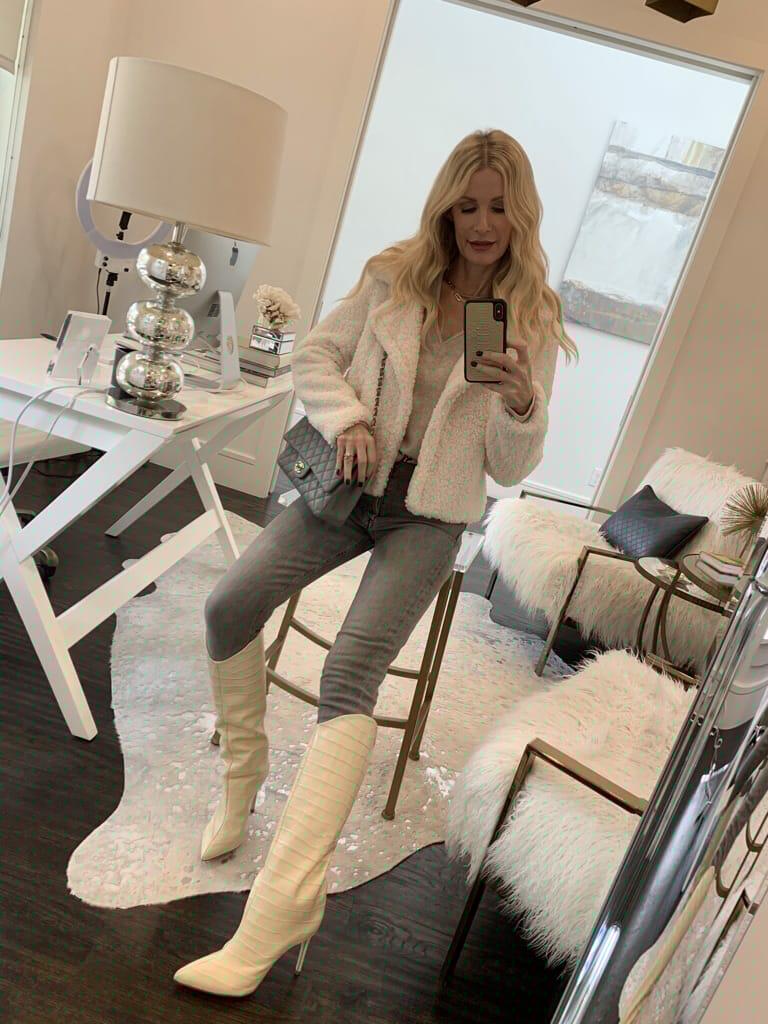 Dallas blogger wearing a winter white outfit with a faux fur jacket and white tall boots