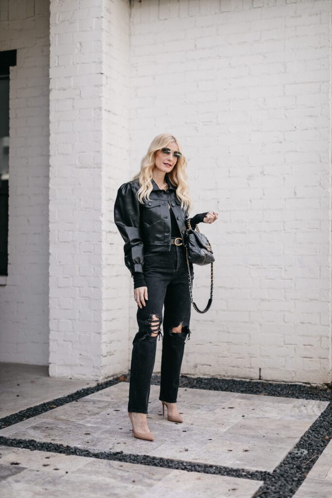 So Heather blog wearing a black puff sleeve faux leather jacket and black denim