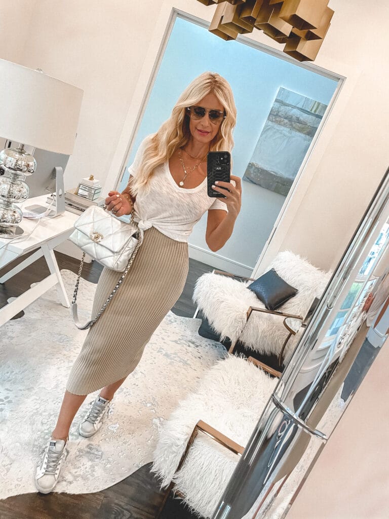 Style blogger So Heather wearing a knit midi skirt and golden goose sneakers