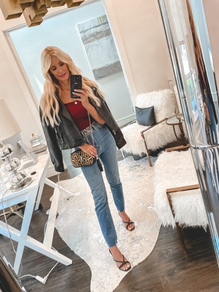 Dallas style blogger wearing a faux leather jacket and medium wash jeans