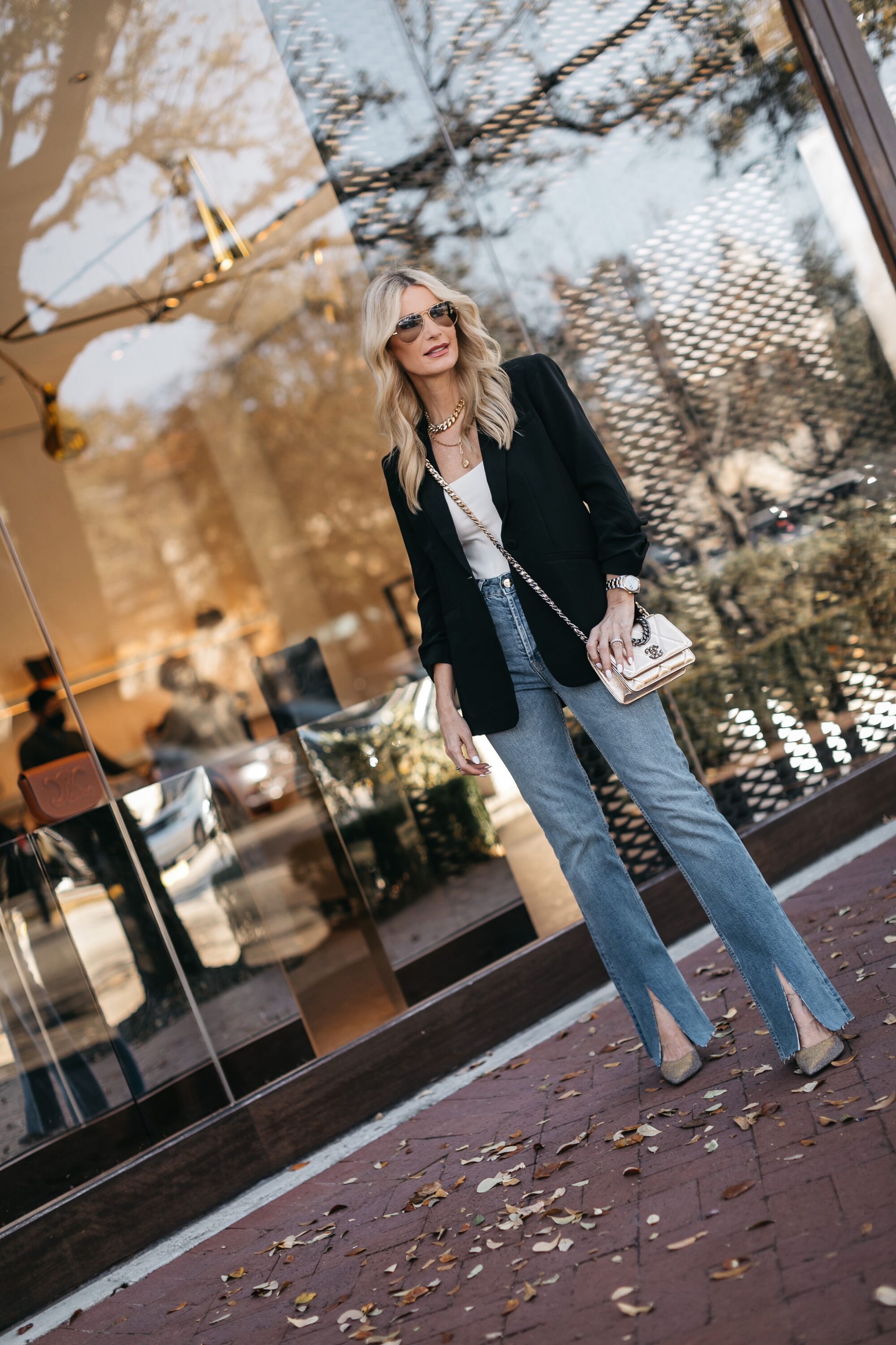 Dallas fashion blogger over 40 wearing black blazer, white bodysuit and denim
