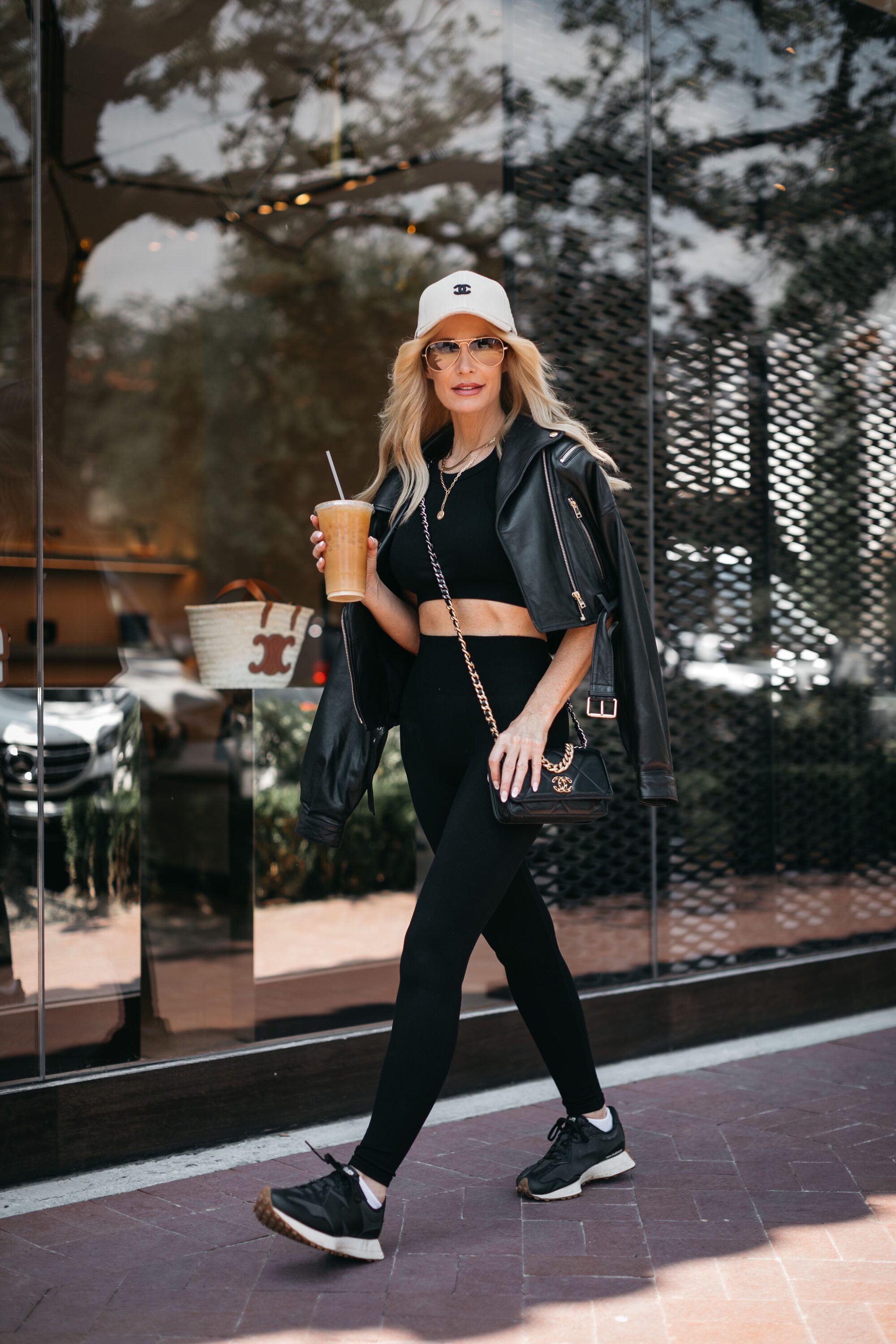 Woman over 40 wearing commando active wear with allsaints leather jacket