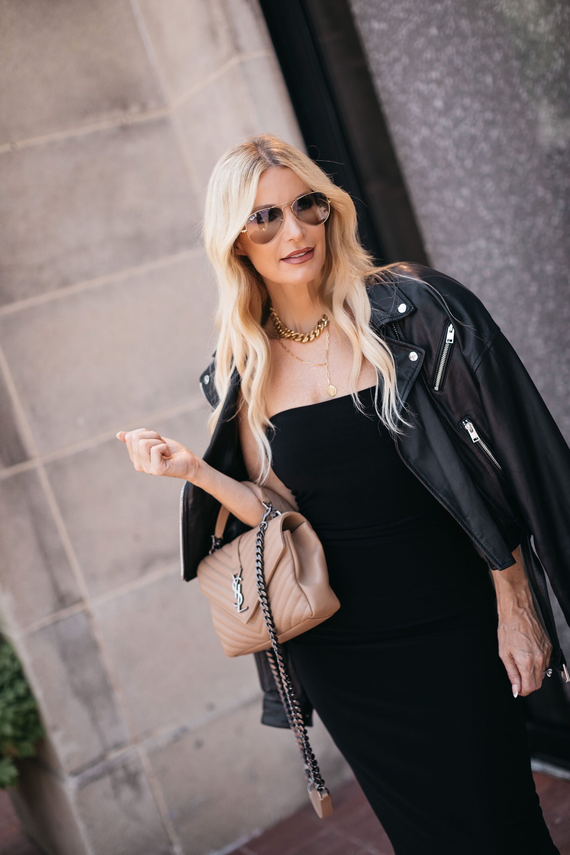 Dallas fashion blogger over 40 wearing leather jacket with black dress