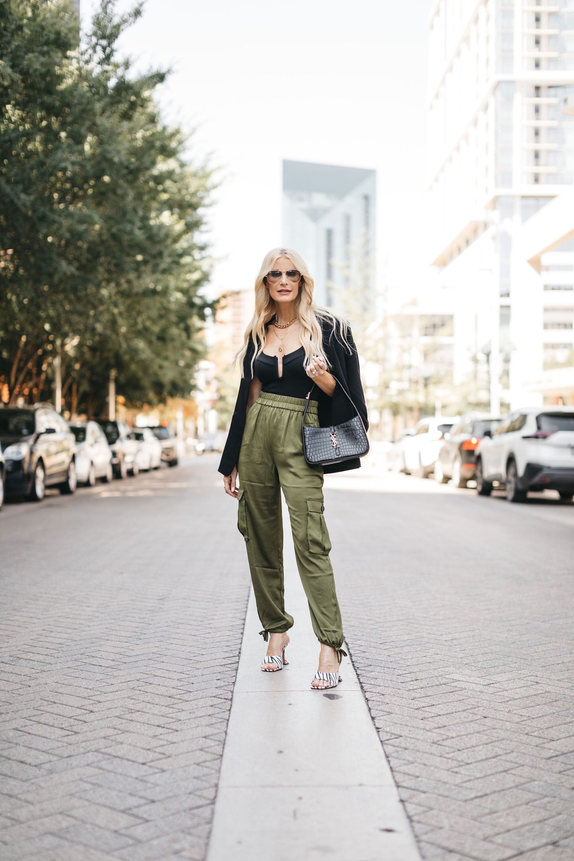 Fashion blogger over 40 wearing toe detail cargo pants with black body suit and blazer from Nordstrom