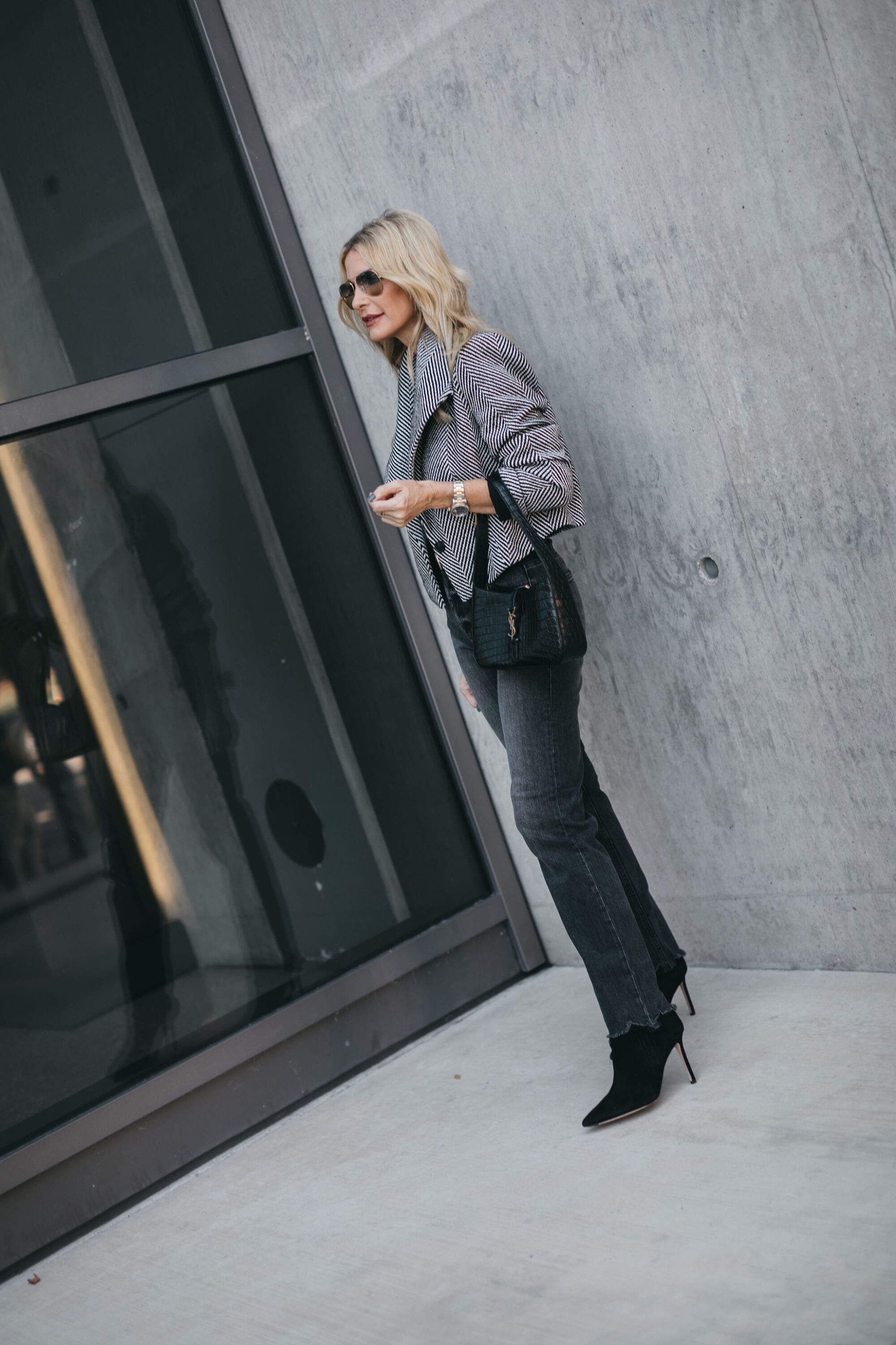 Woman over 40 wearing Halogen cropped blazer, stella raw hem jeans and Veronica Beard Ankle booties.