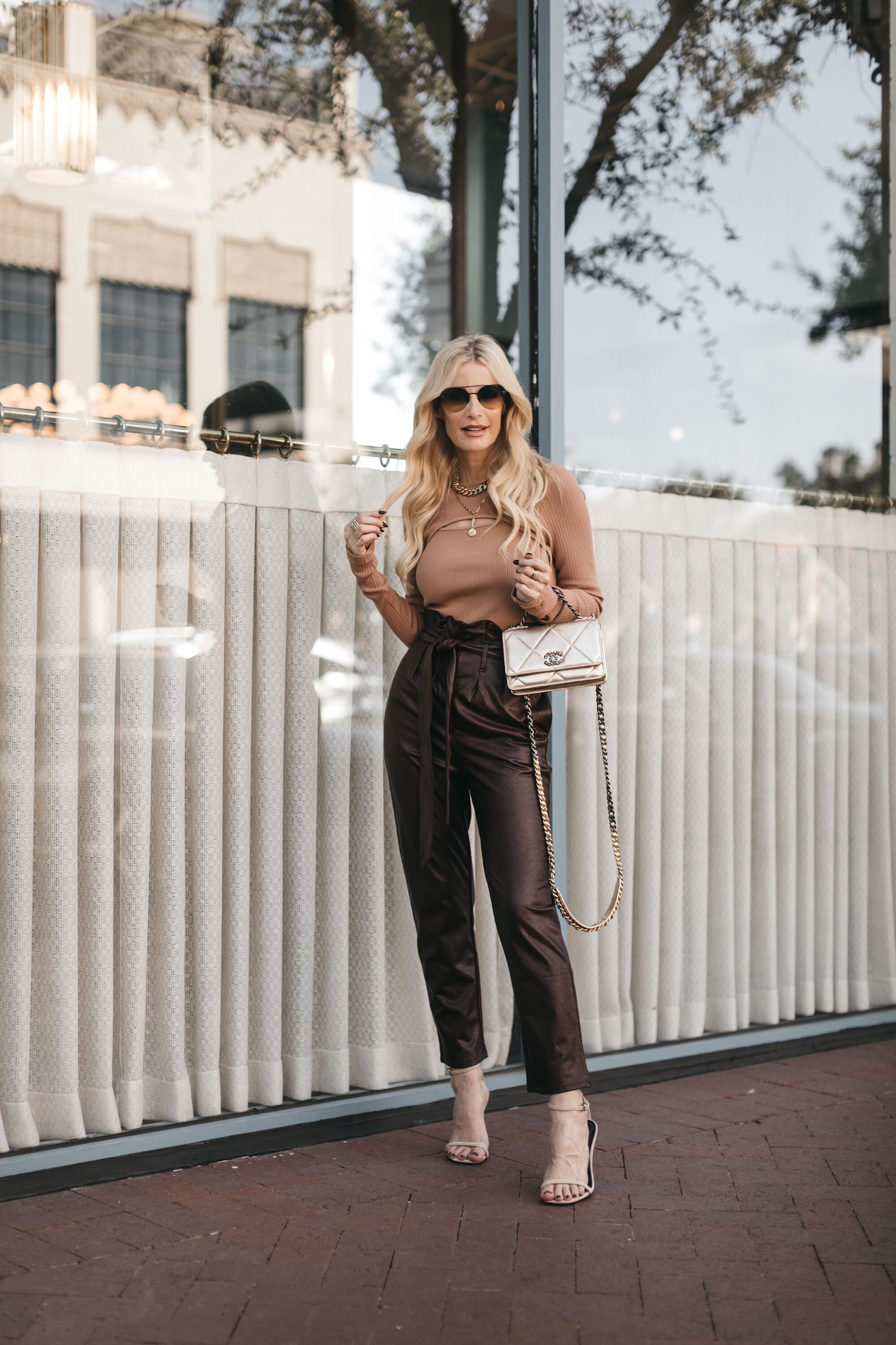 Dallas fashion blogger wearing slimming pants with cut out sweater and pin heels.