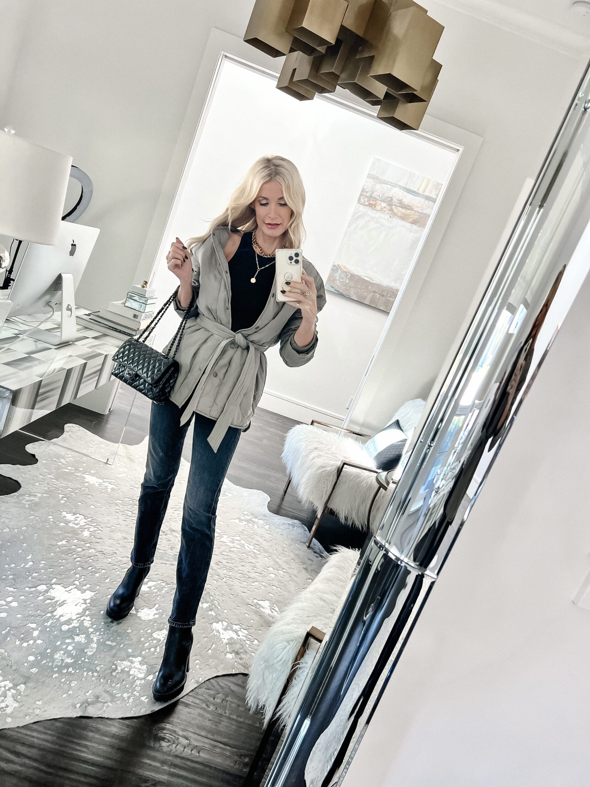 woman over 40 wearing lug sole booties with green quilted jacket and mother jeans as example of how to style boots.
