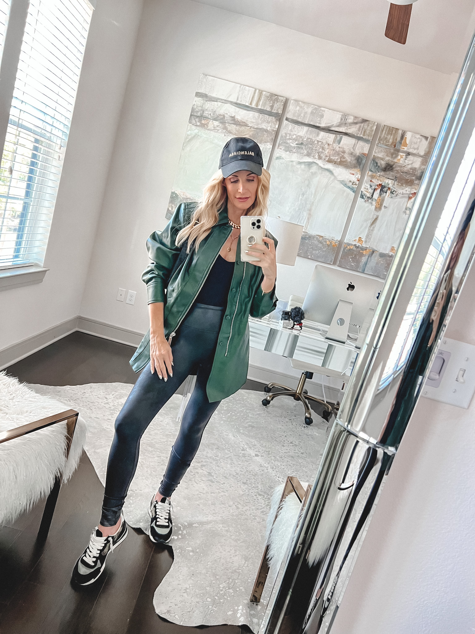 Over 40 fashion influencer wearing favorite faux leather leggings and and bodysuit on major sale.